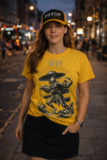 Woman wearing a yellow t-shirt with graphic design and a cap on a city street at night.