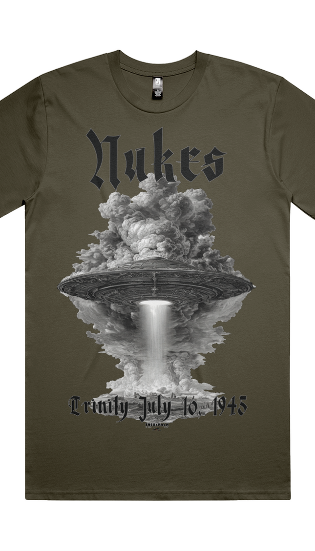 Green t-shirt with a graphic design of a UFO and cloud, featuring the text 'Nukes' and 'Lemly July 16, 1945'.