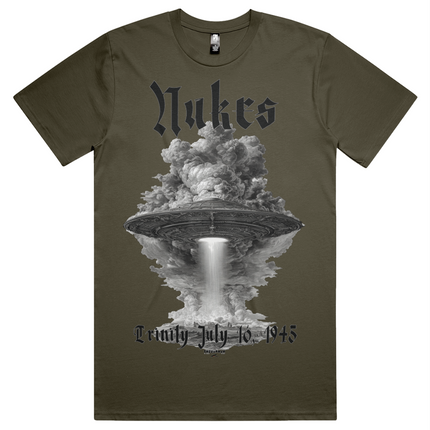 Green t-shirt with a graphic design of a UFO and cloud, featuring the text 'Nukes' and 'Lemly July 16, 1945'.